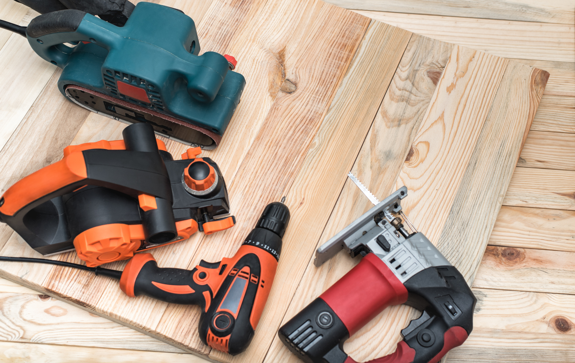 A bunch of tools are sitting on top of a wooden table.