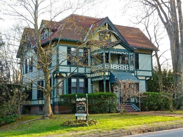 A large house with a sign in front of it