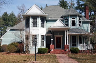 A large house with a brick walkway leading to it