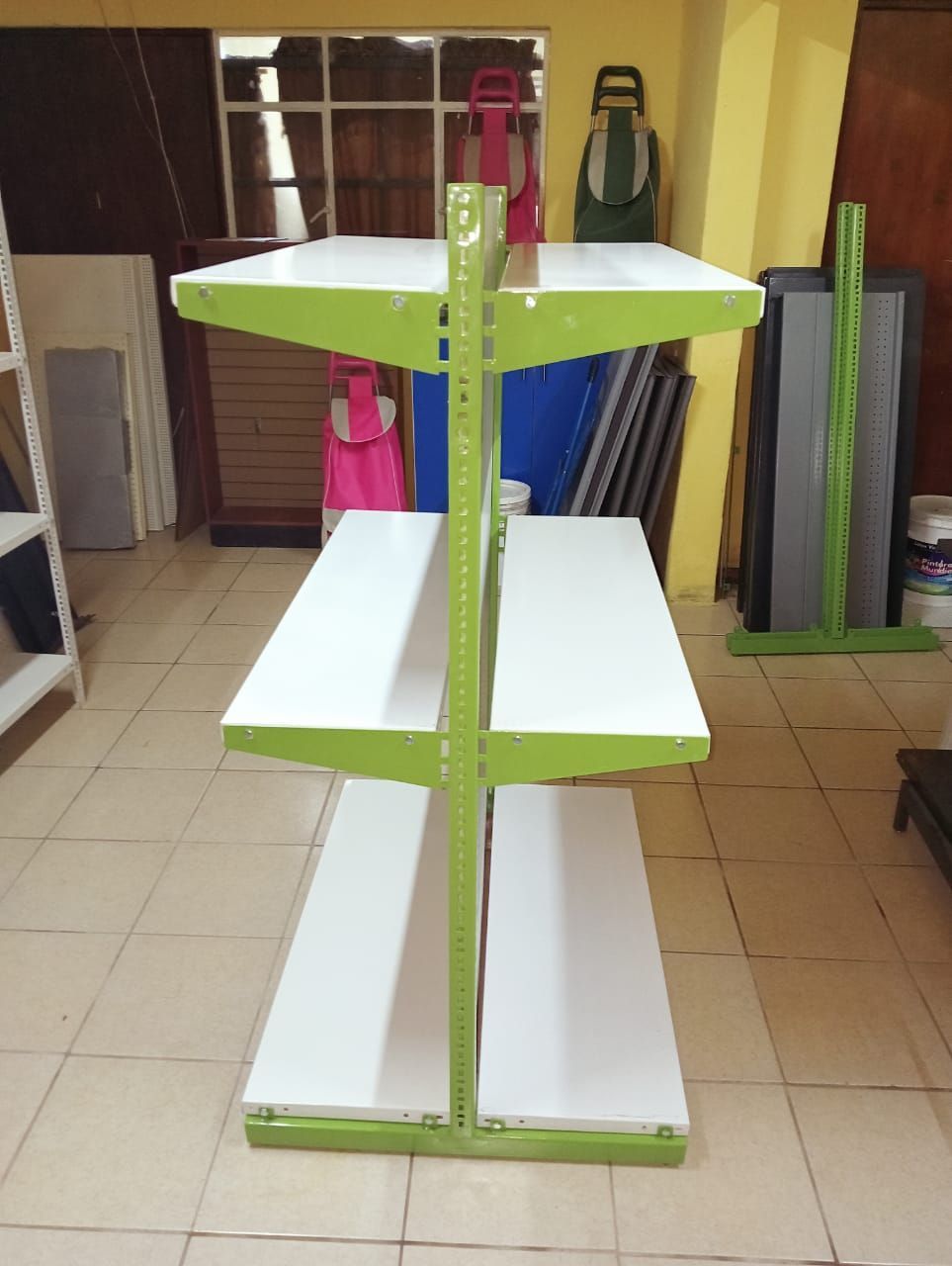 Una estantería verde y blanca en una habitación.