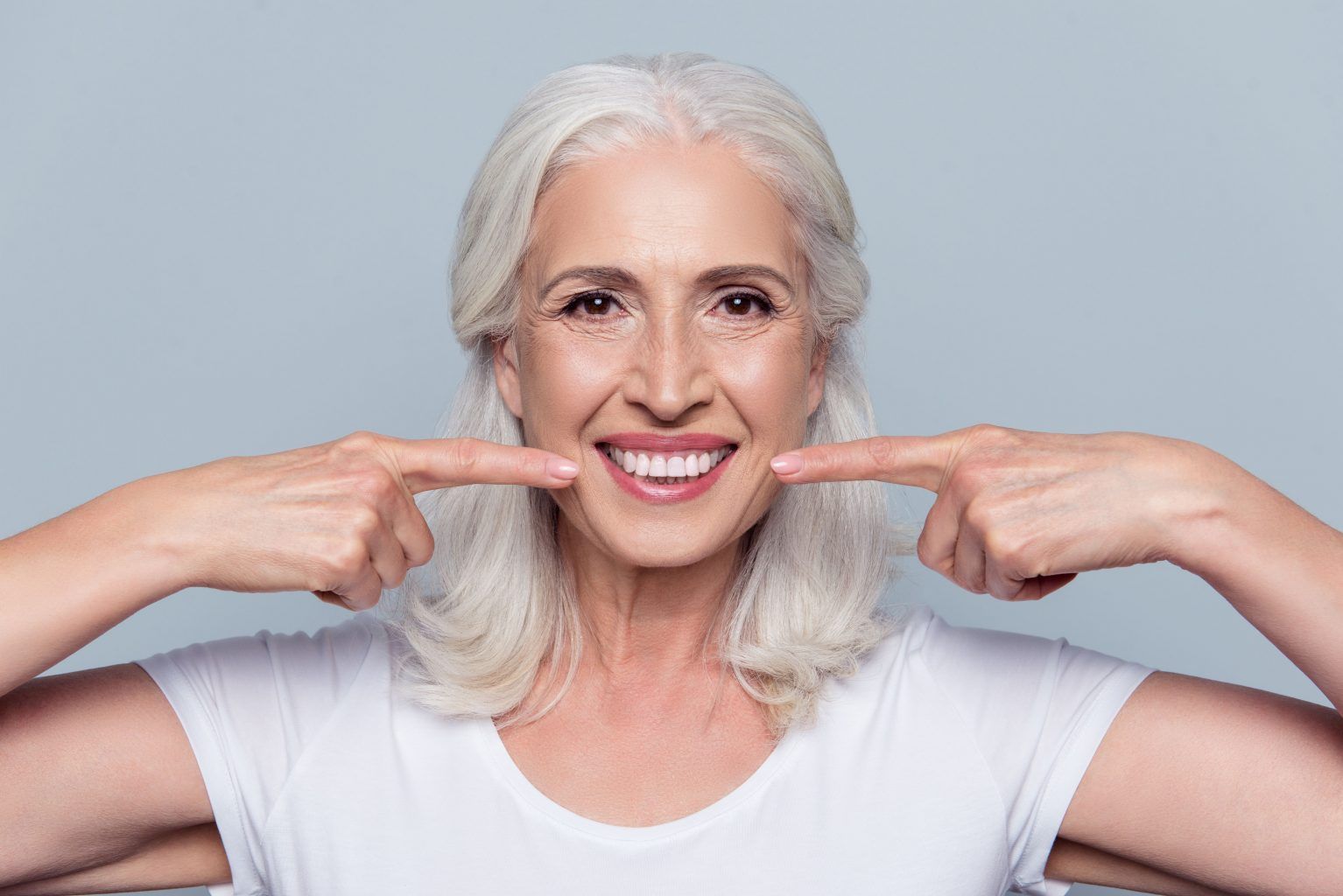 old woman smiling | Custom teeth whitening in Monroe Township, NJ for a brighter smile.