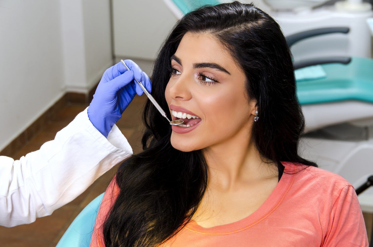 dentist checking womans teeth