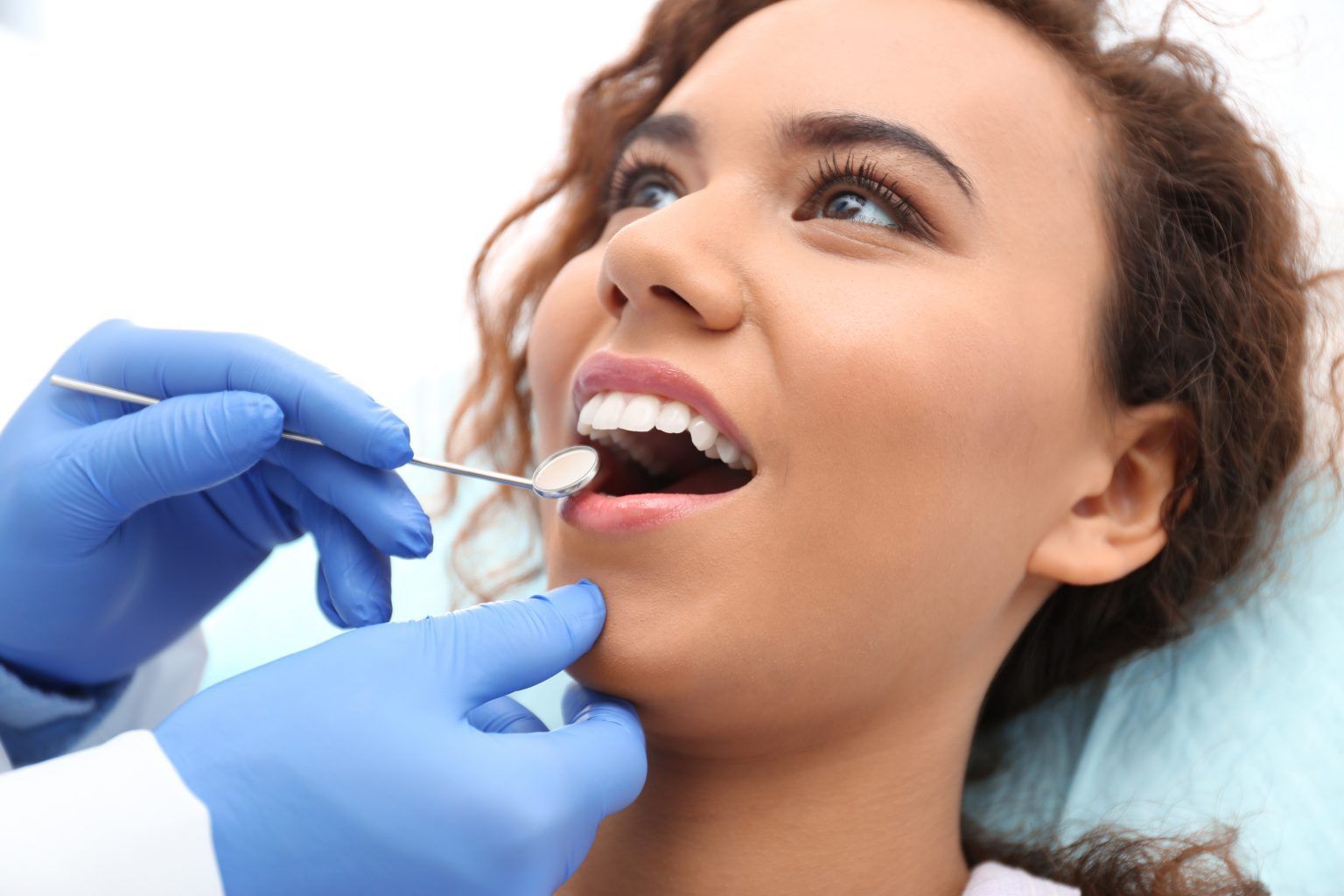 dentist checking a womans teeth