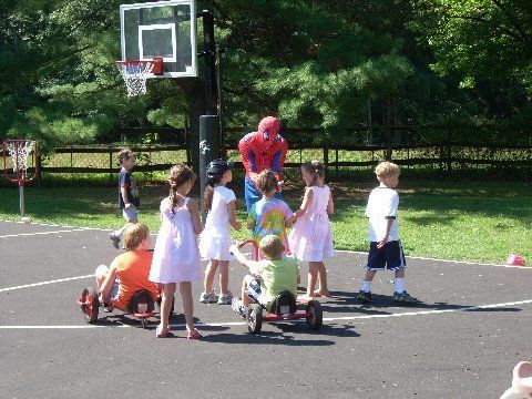 A group of children are playing on a basketball court