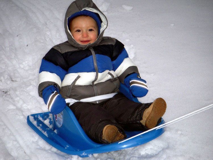 A group of children are playing in the snow