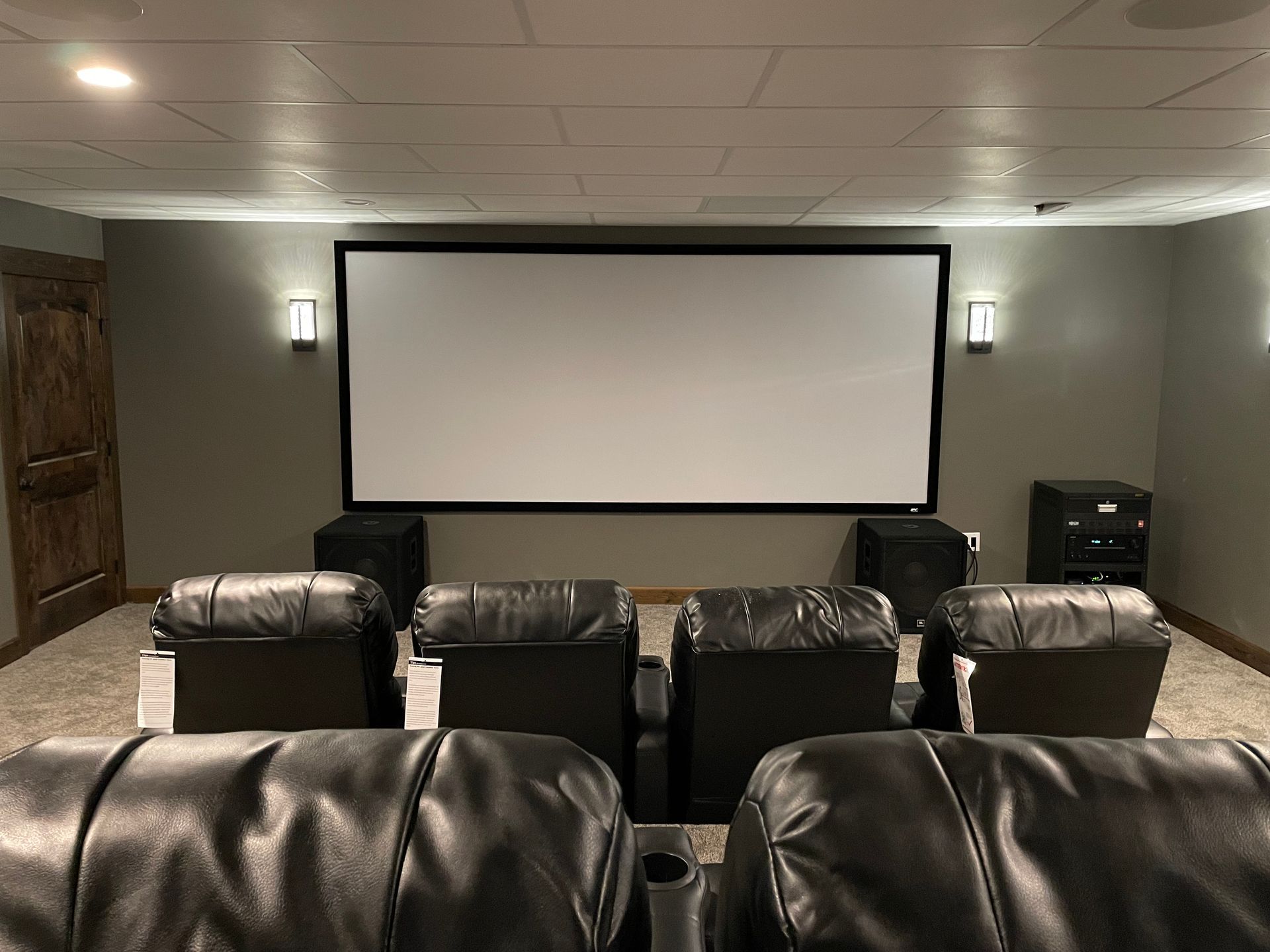 Extreme Dolby Atmos Home Theater designed and tuned to THX Specifications - THX Certified KEF Ci200RS-THX speakers behind the woven acoustically transparent (NOT perforated) Cinemascope 2.35/1 screen.  Crown amplification, dual JBL JRX218S Subs, RTI iPad control.  This room is completely surrounded by concrete ON ALL SIX SURFACES - Sound pressure levels in the seating area can exceed 120 db (unweighted). Epson Projection