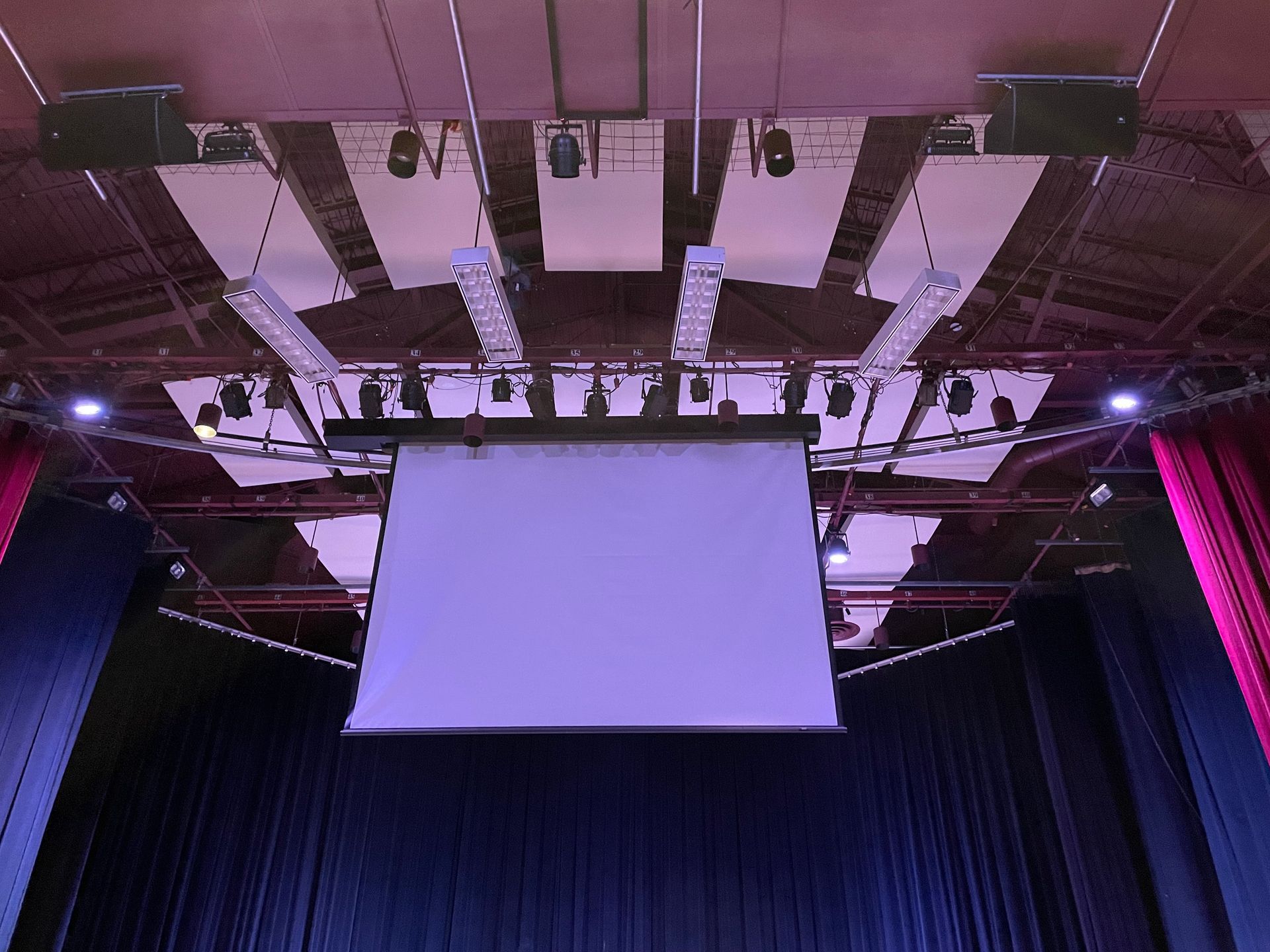 Auditorium with Digital Projection®, Martin® stage lighting, RPG diffusers, JBL AE Series speakers, Shure, DBX