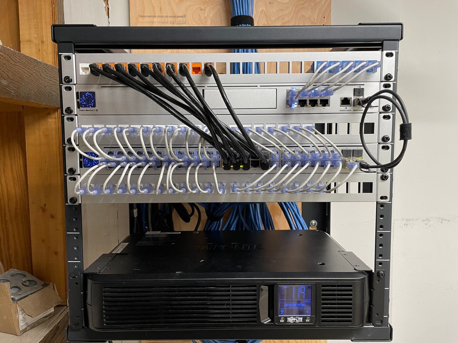 A server rack with a lot of wires coming out of it