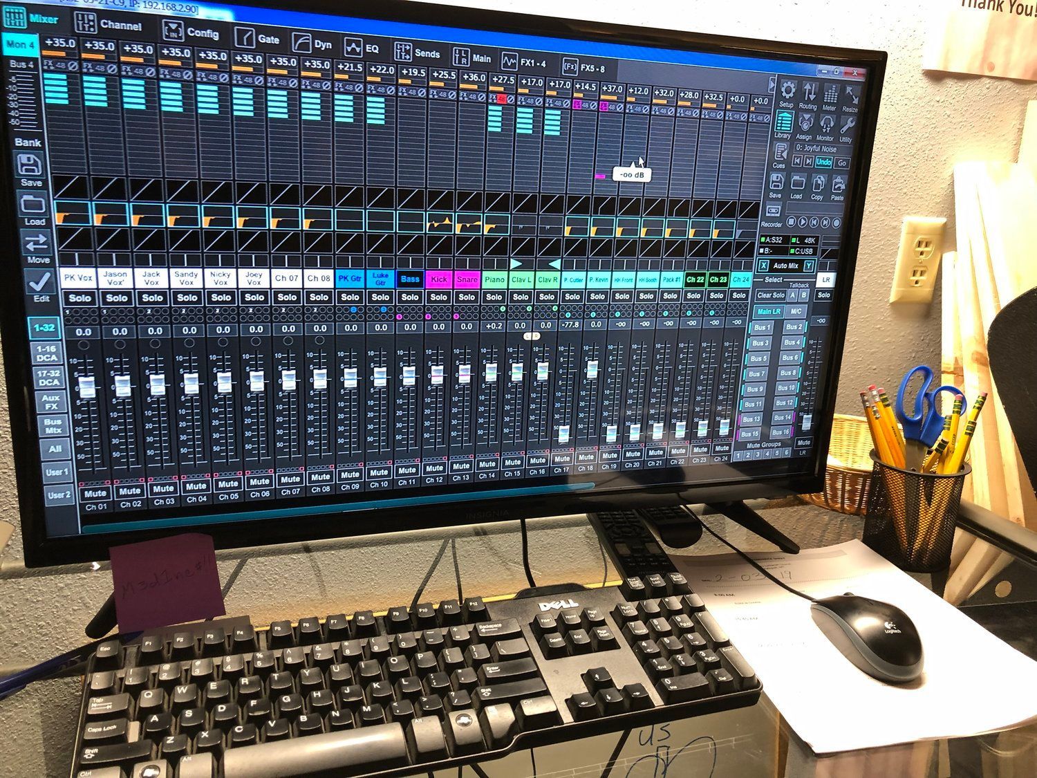 A computer monitor is sitting on a desk next to a keyboard and mouse.