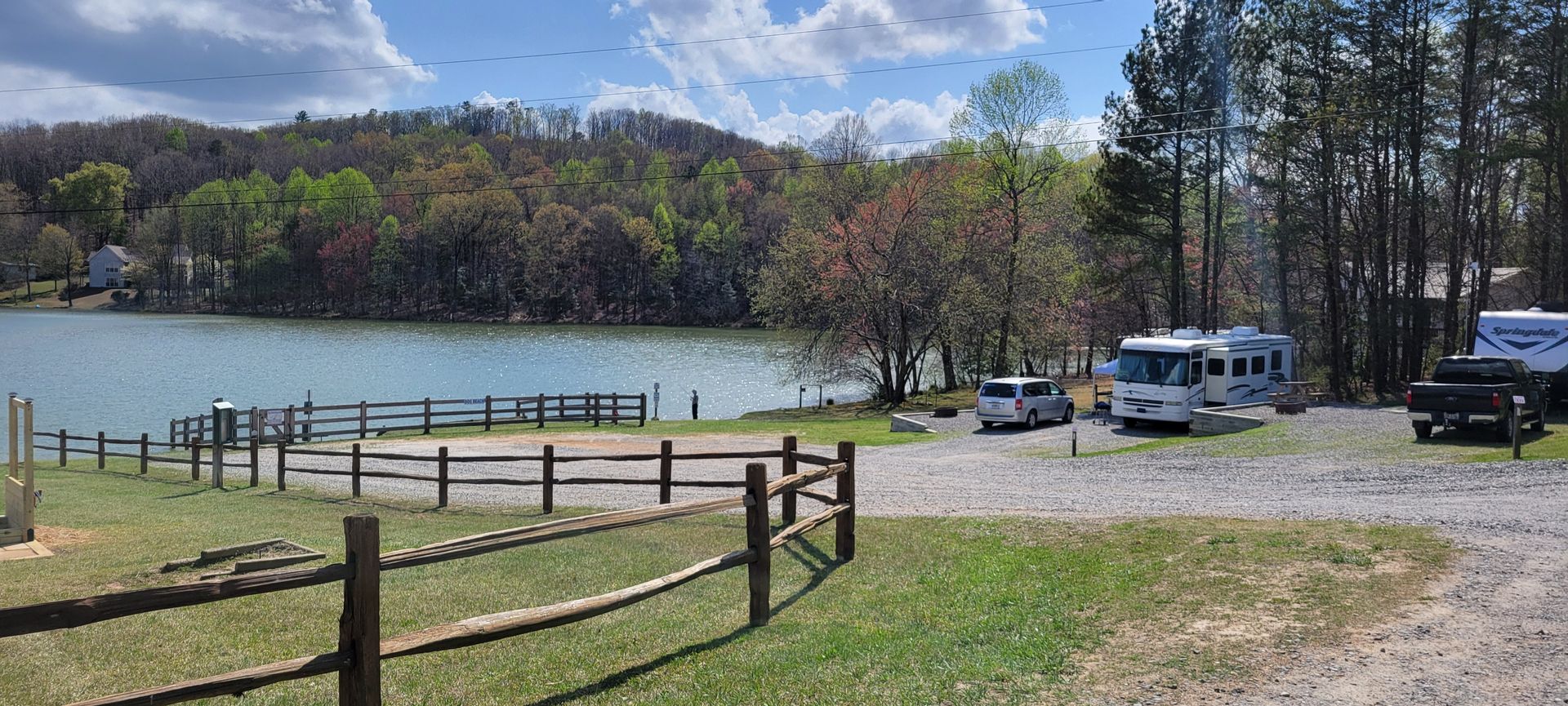 A fenced in area with a lake in the background