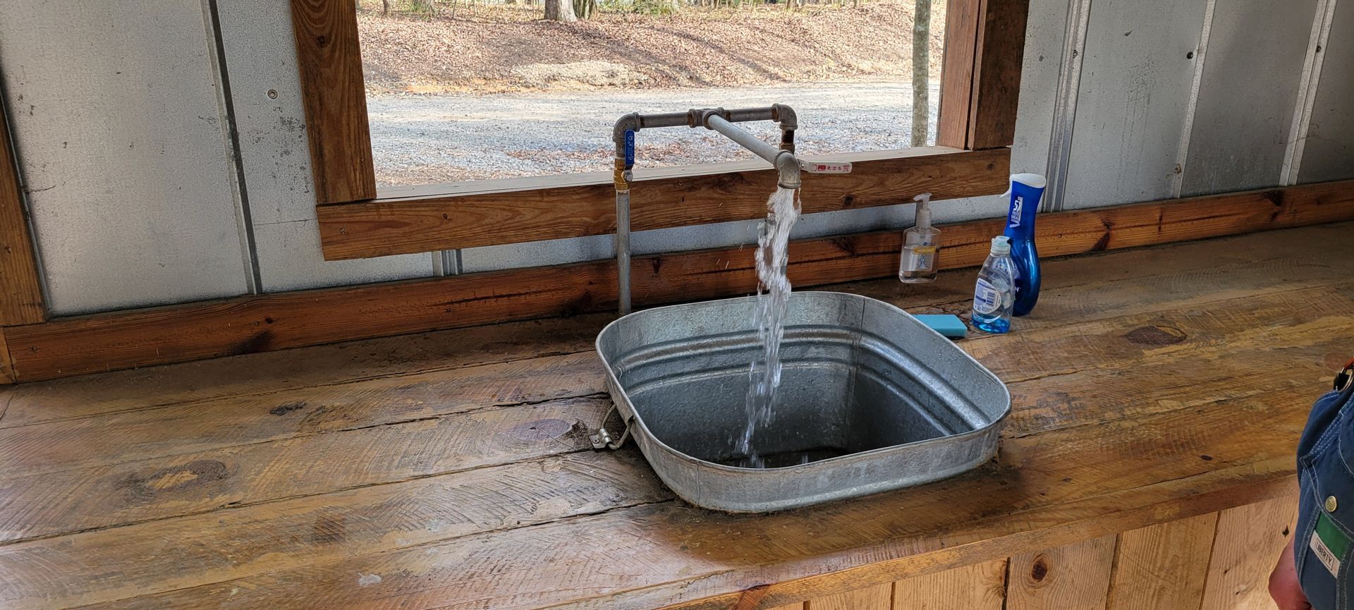 A metal sink with water running out of it
