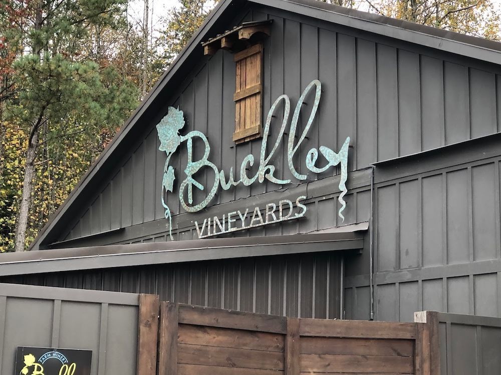 A building with a sign that says buckley vineyards on it