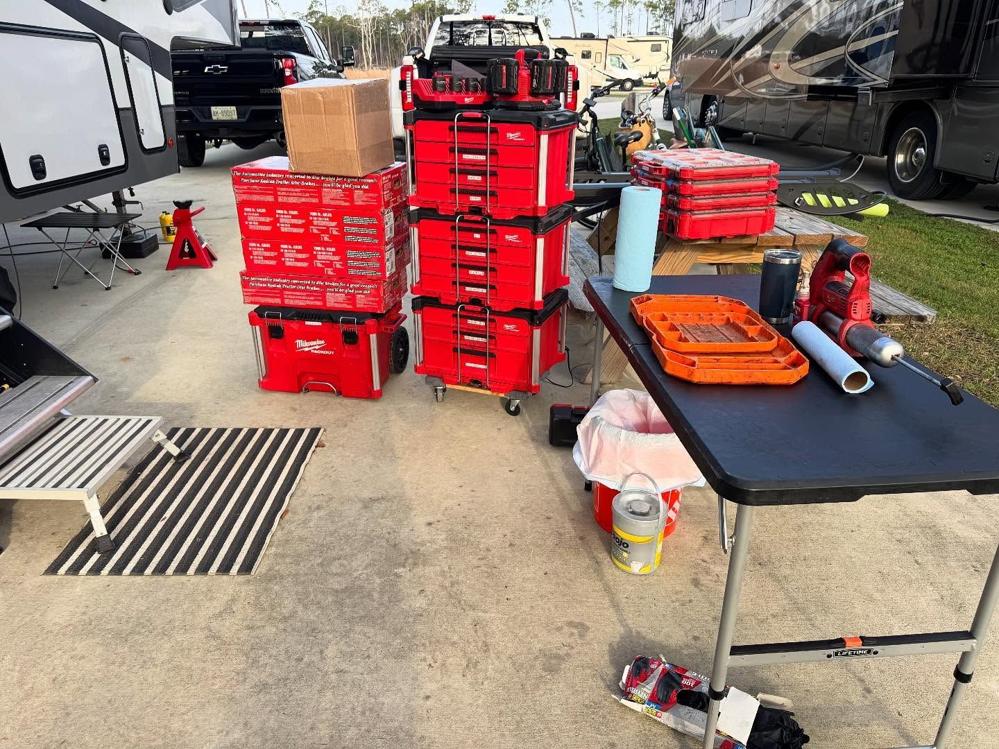 A table with a lot of tools and boxes on it