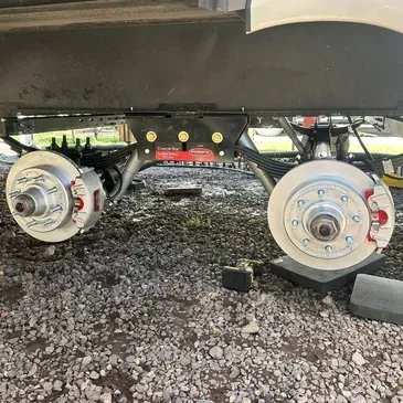 A rv is sitting on top of a pile of gravel.