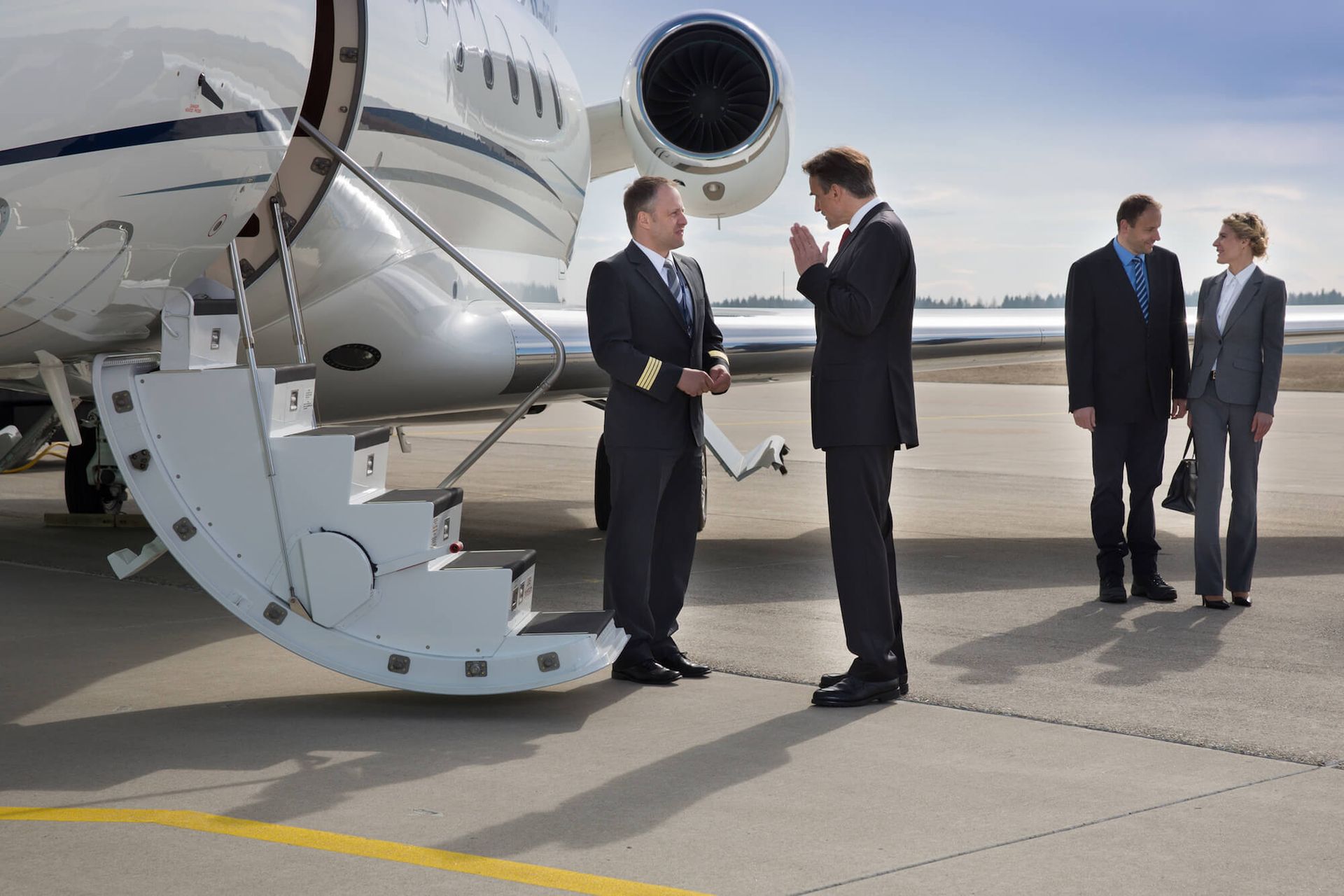 Professional chauffeur assisting a passenger into a luxury limousine in Portland, Oregon