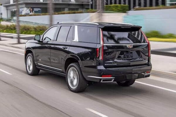 Professional chauffeur assisting a client into a town car at a corporate event in Portland, Oregon