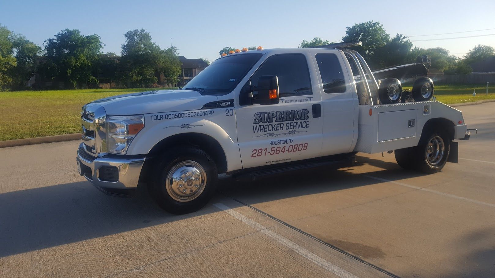 White tow truck parked on asphalt