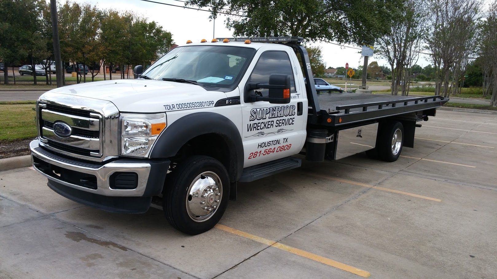 White tow truck parked in a lot