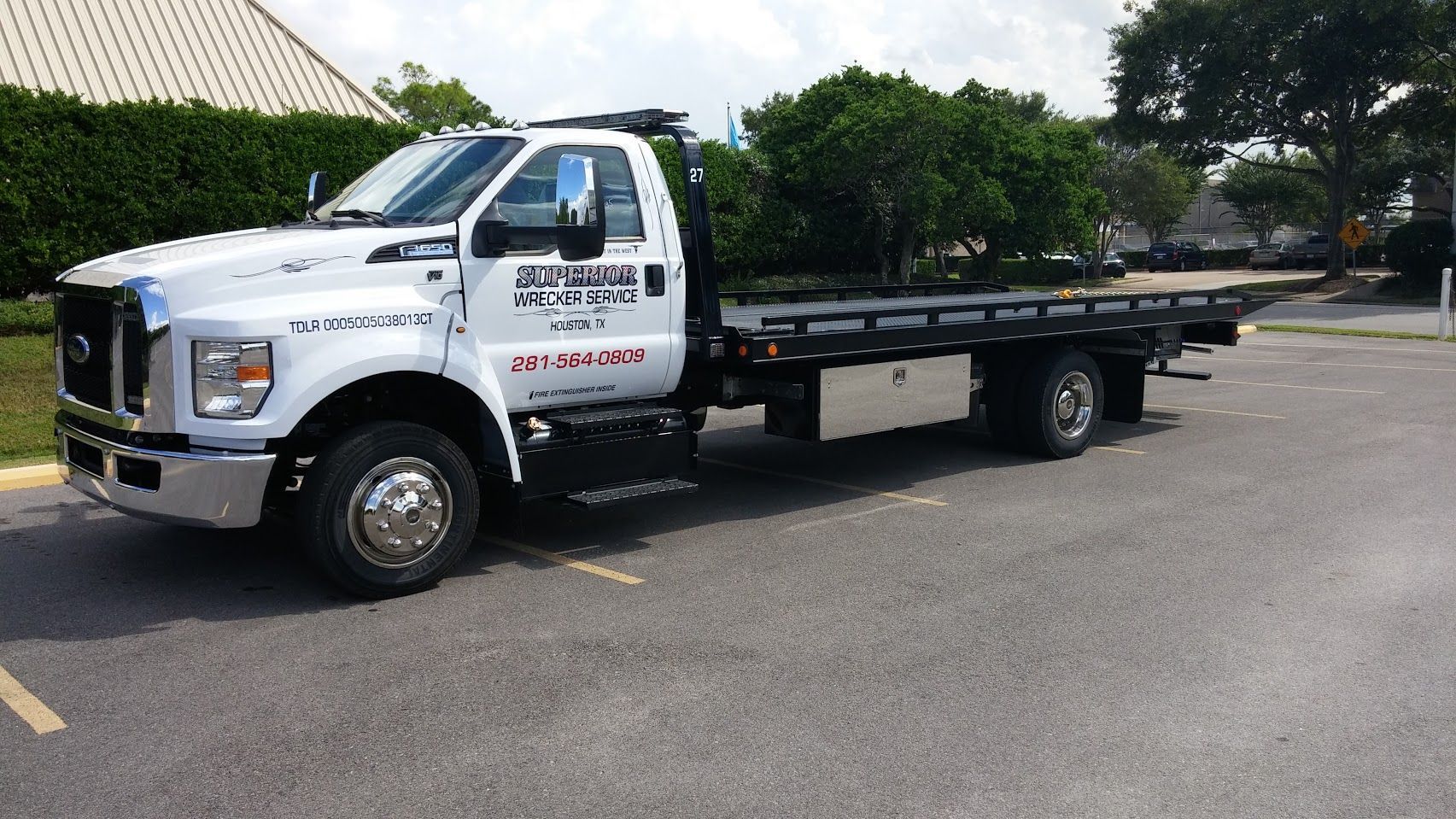 White tow truck parked on asphalt