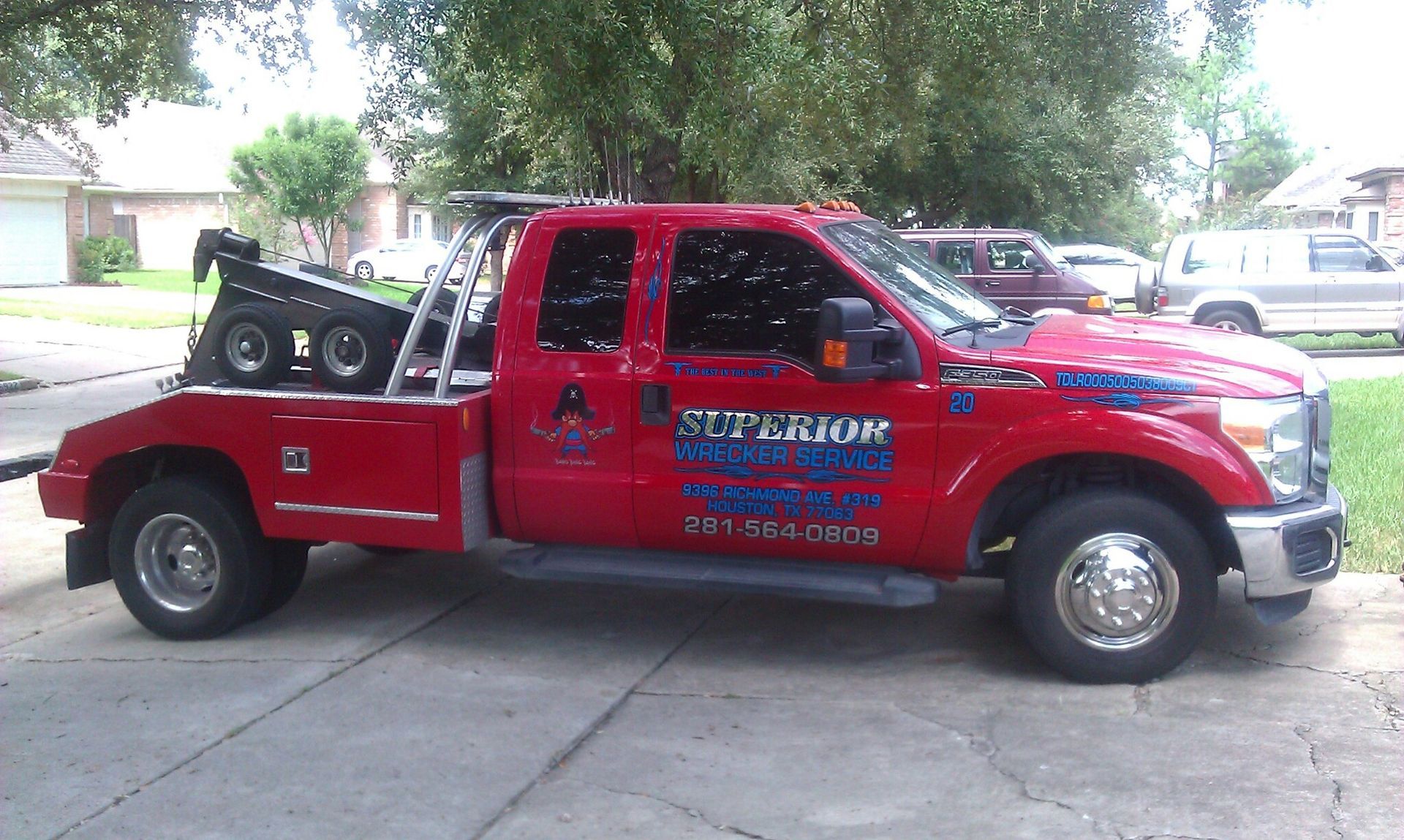 Red tow truck parked on a driveway