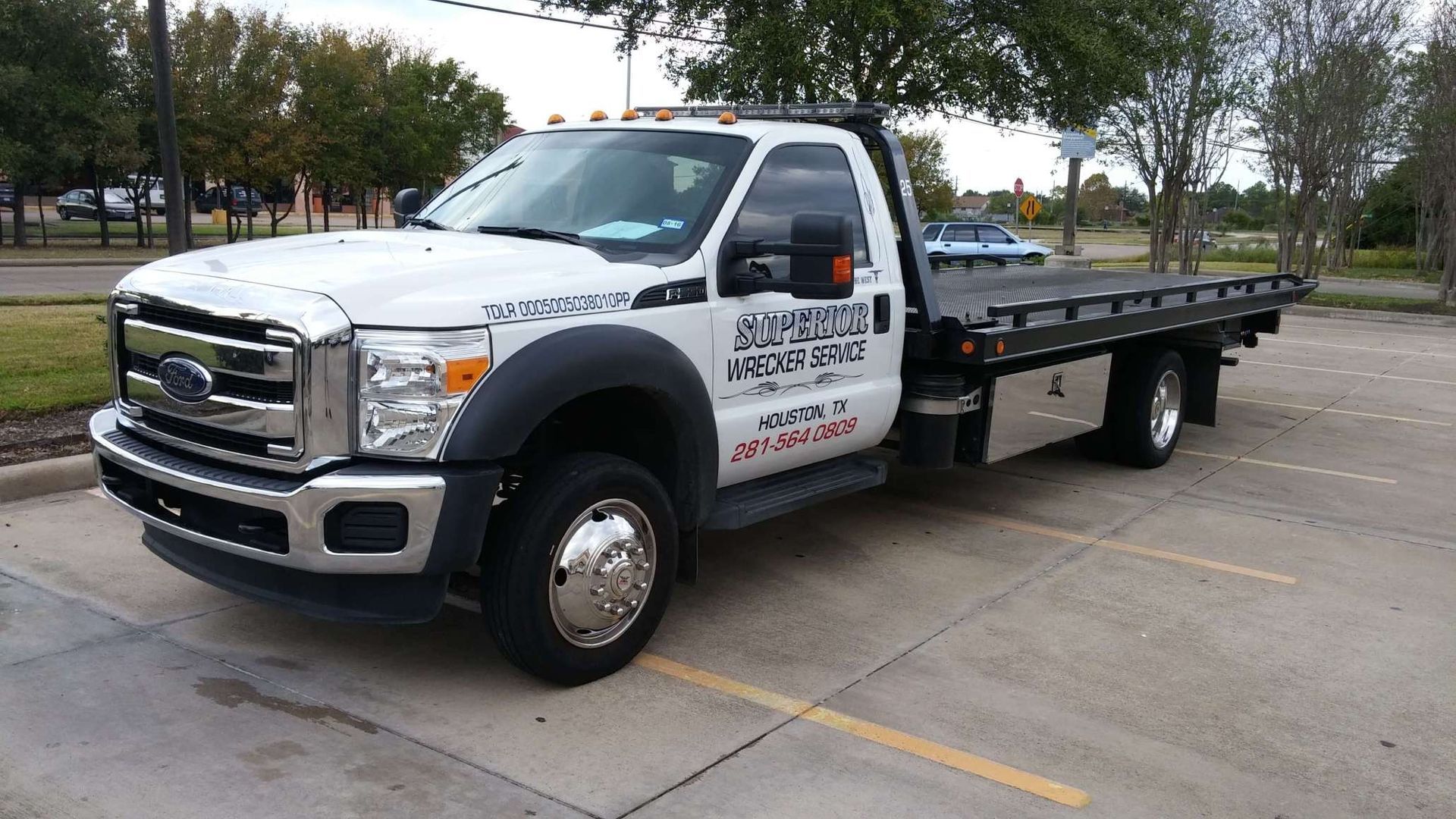 White tow truck parked on a concrete surface