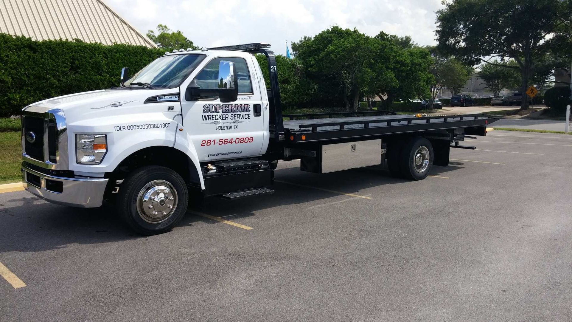 White tow truck parked on asphalt