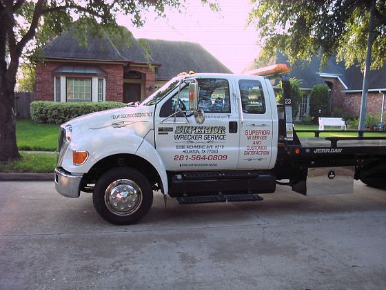 White tow truck parked on a residential street