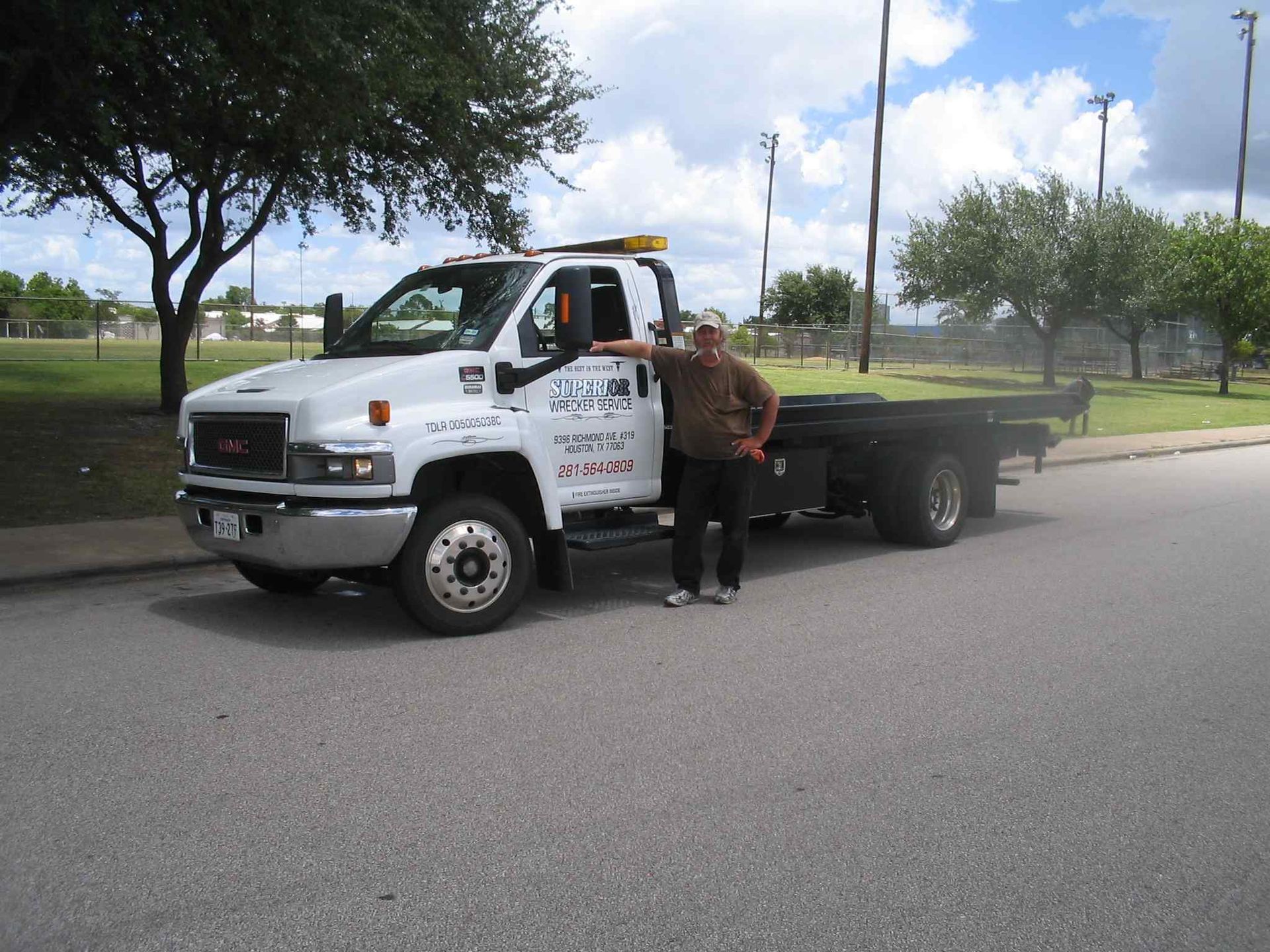 Man standing next to tow truck