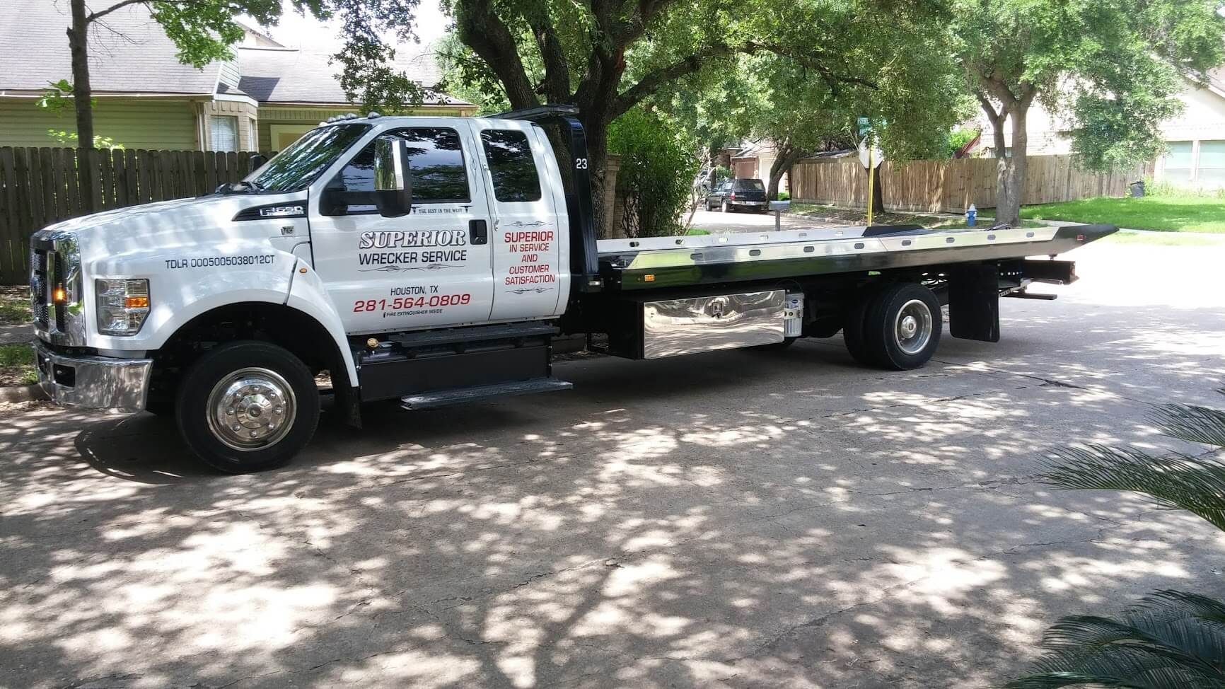 White tow truck parked on a driveway