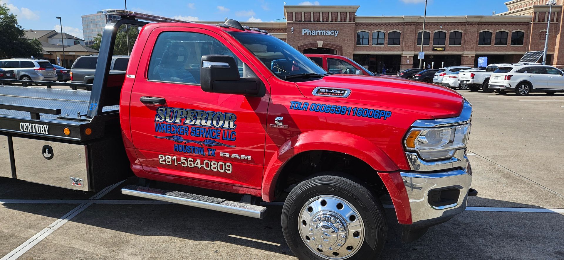 Red tow truck parked in a parking lot