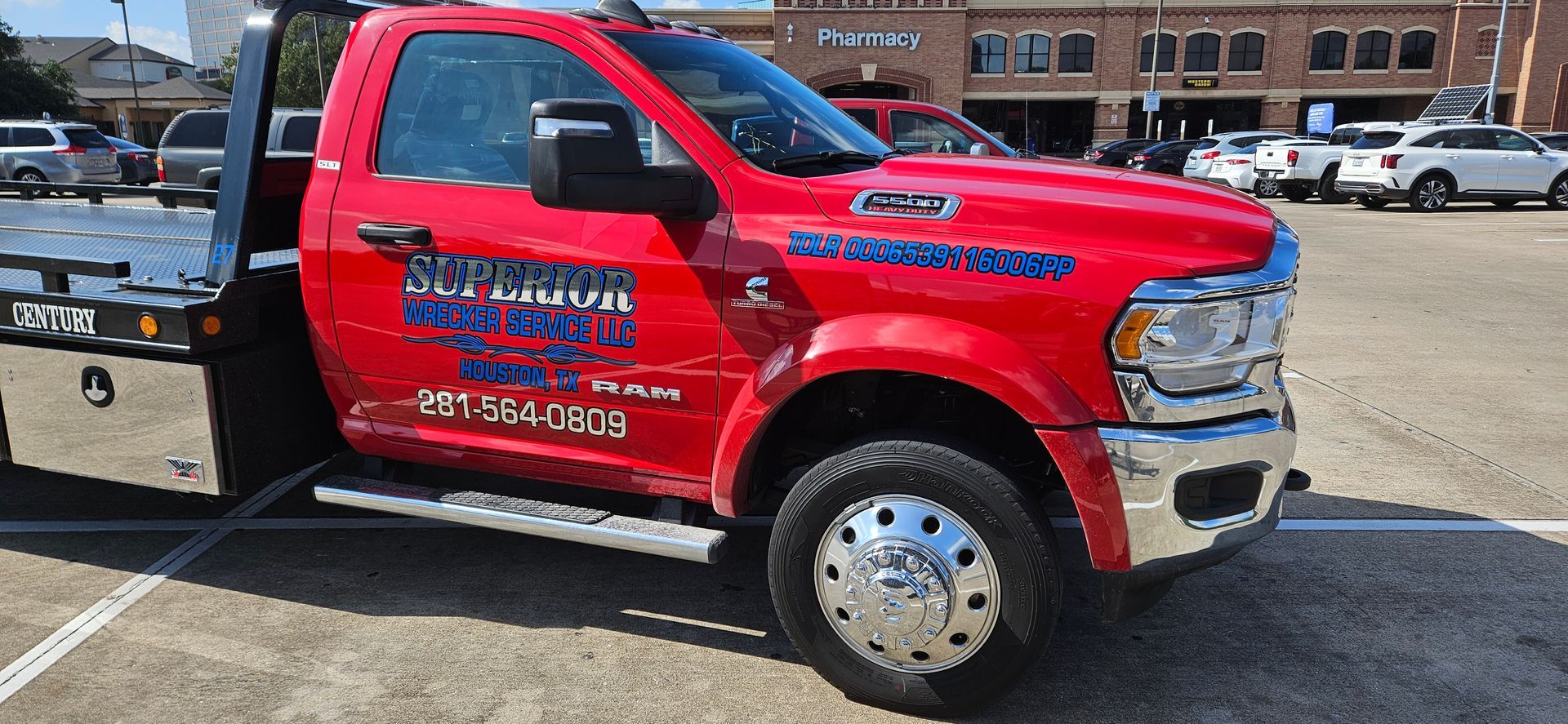 Red tow truck parked on a paved area