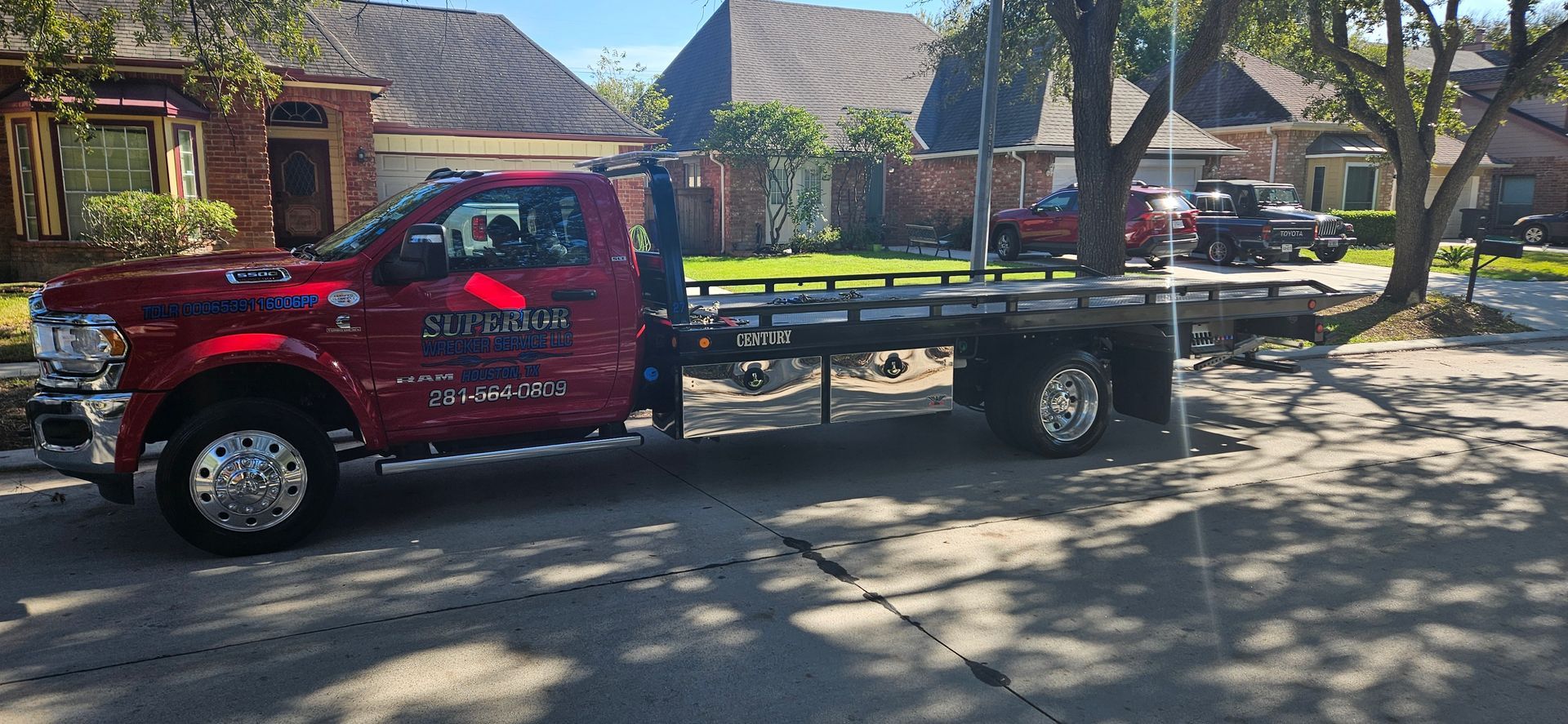 Red tow truck parked on a residential street