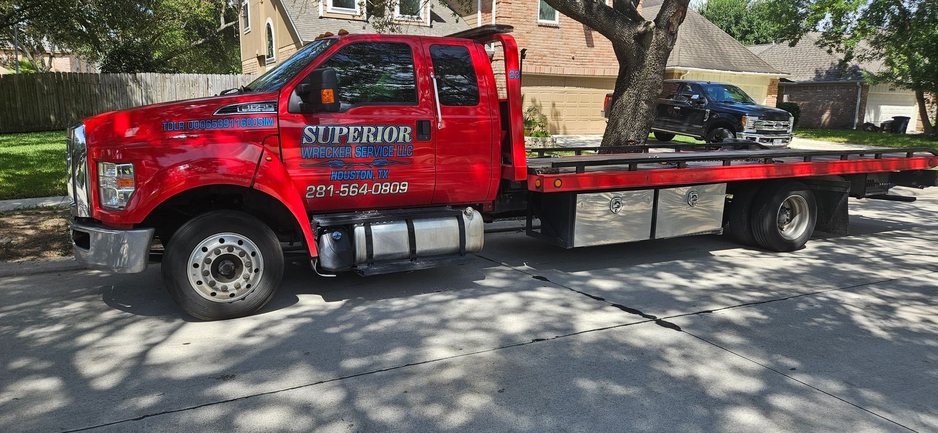 Red tow truck on a sunny street