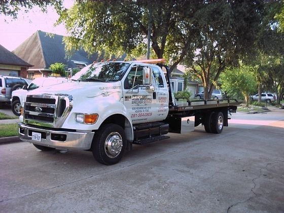 White tow truck parked on a residential