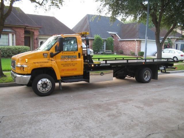Yellow tow truck parked on a residential street