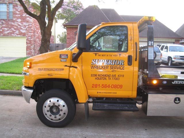 Yellow tow truck parked on a residential street