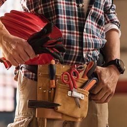  Handyman wearing a plaid shirt and a tool belt, holding a red hard hat and gloves, ready for repair services
