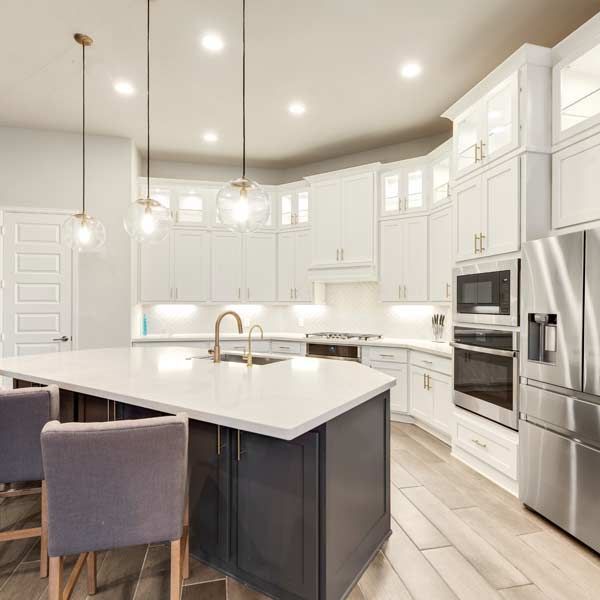 Modern Kitchen Renovation with island, gray cabinets, and stainless steel appliances.