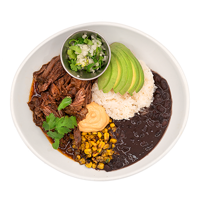 Bowl with beef, rice, beans, avocado, corn, and garnish.