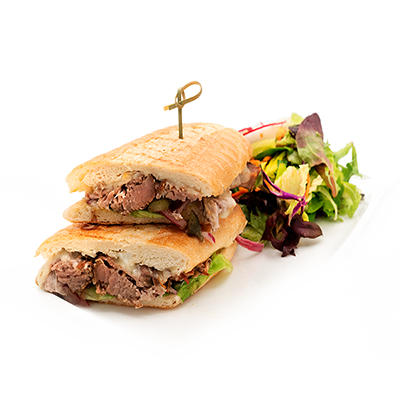 A grilled sandwich cut in half, with a side salad, on a white plate.