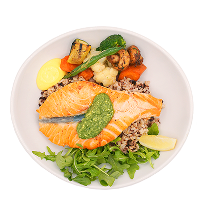 Grilled salmon bowl with vegetables and herbs.