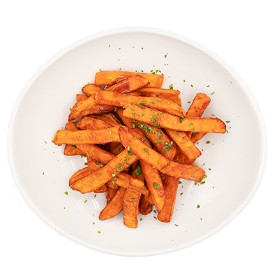 Sweet potato fries in a white bowl, sprinkled with parsley.