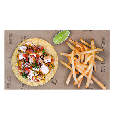Taco with chicken and salsa, lime wedge, and fries on a brown paper-covered board.