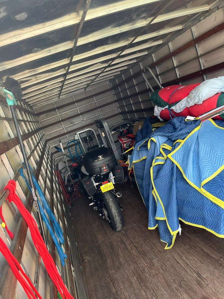 A Motorcycle is Sitting in the Back of a Truck — Ready To Move in Mullumbimby, NSW