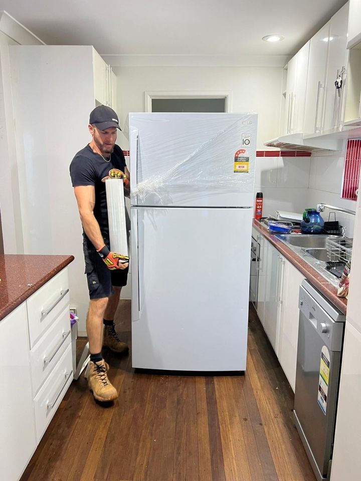 A Man is Standing Next to a Refrigerator in a Kitchen — Ready To Move in Mullumbimby, NSW