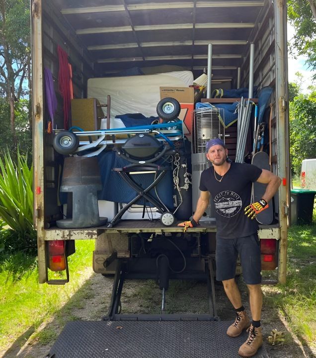A Man in a Branded Shirt is Standing Behind a Truck — Ready To Move in Mullumbimby, NSW