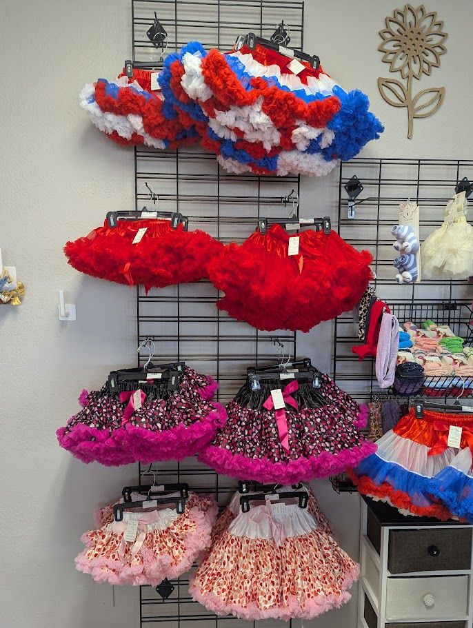 A bunch of red white and blue skirts hanging on a wall