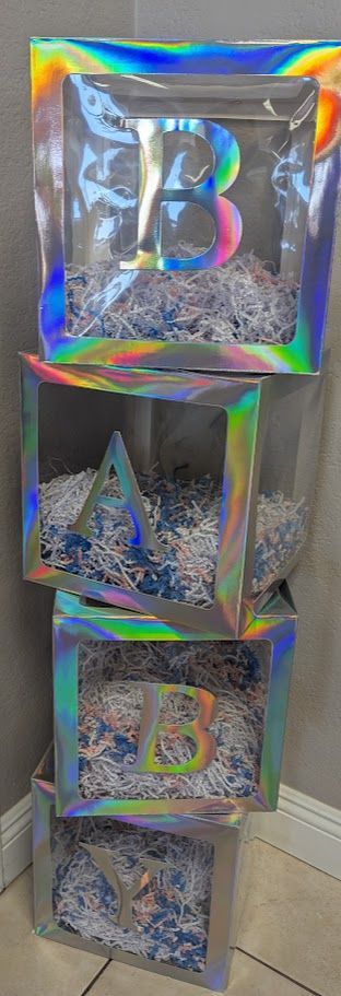 A stack of clear boxes filled with shredded paper.