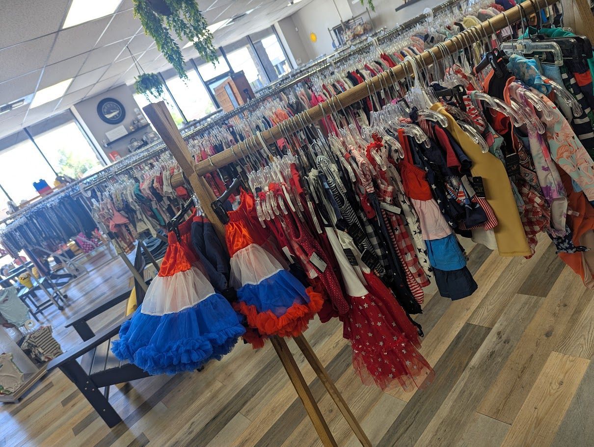 A store filled with lots of clothes hanging on racks.