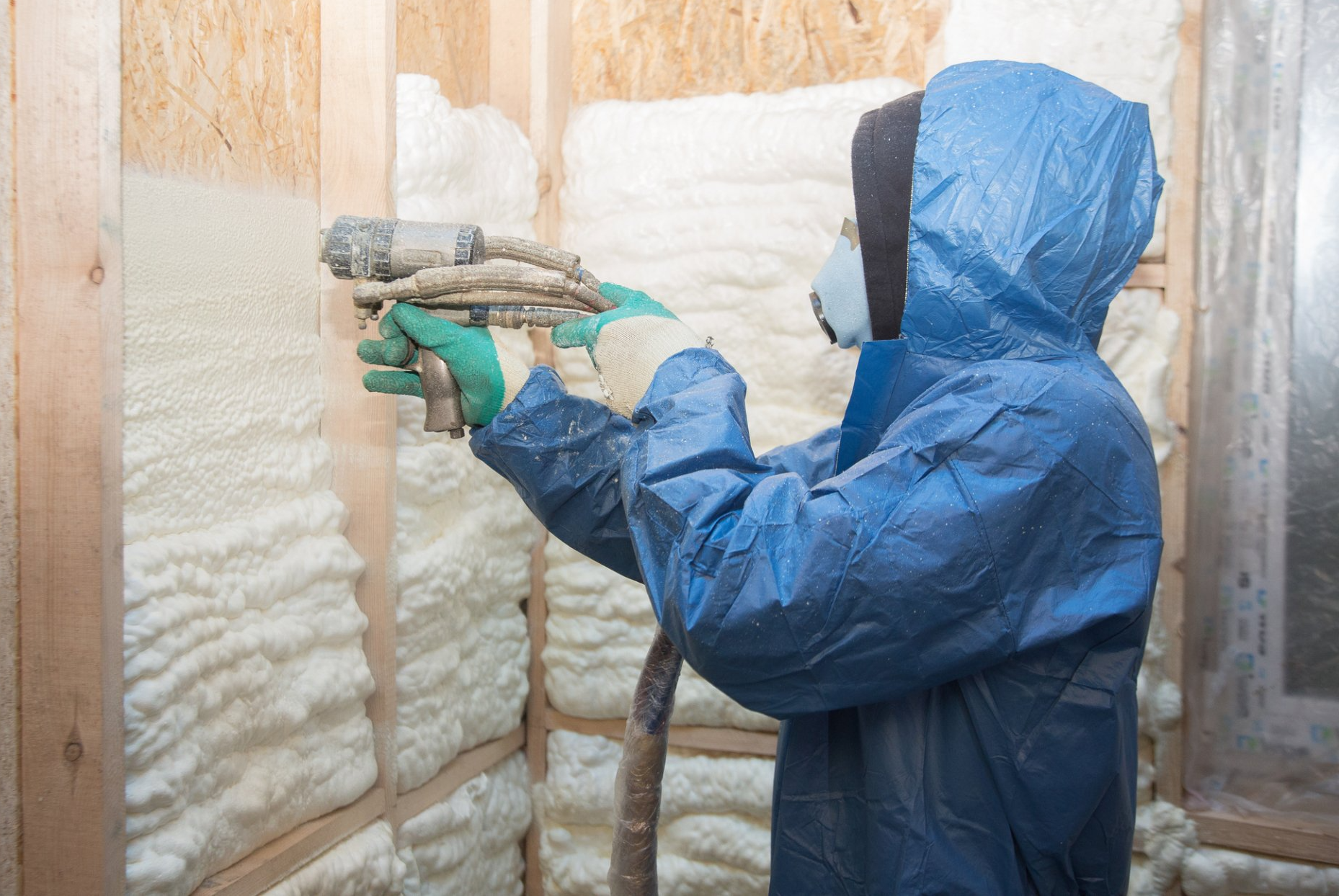 person applying insulation to house